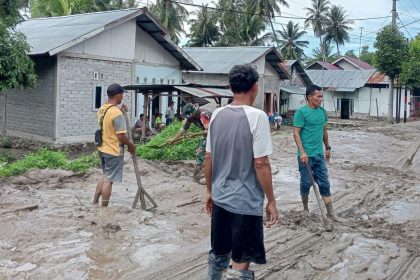 Warga setempat dibantu TNI-Polri membersihkan ruas jalan Palu-Bangga pasca diterjang banjir lumpur di Dusun Salubi, Desa Bobo, Kecamatan Dolo Barat, Sigi. Sumber Foto: Istimewa
