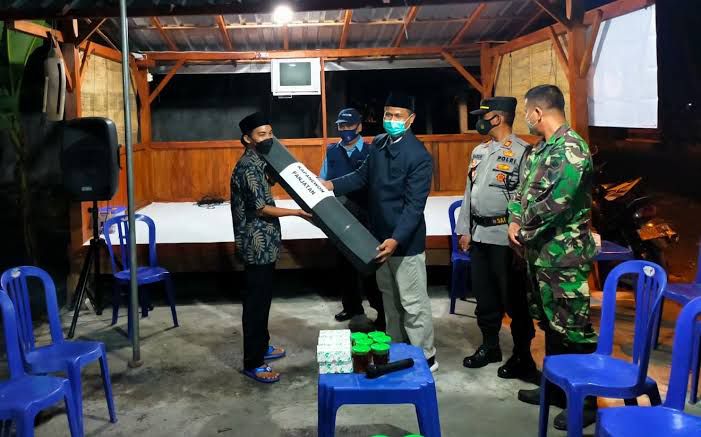 Warga yang bertugas ronda sedang mengumpulkan uang jimpitan dari salah satu rumah warga RT 12 Desa Gunung Makmur Kecamatan Antang.