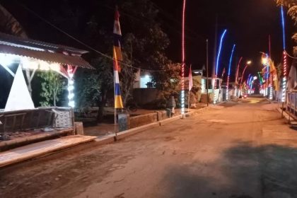 Ornamen lampu warna-warni dan bendera merah putih saat malam hari di Desa Sambilawang. Sumber : Farisma/jprm