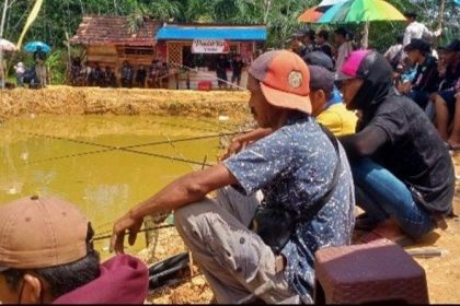 peserta lomba mancing dalam rangka Hari Ulang Tahun (HUT) ke 40 Desa Pandan Sari, Kecamatan Karang Bintang, Kabupaten Tanahbumbu, antusias melemparkan kail pancingnya ke kolam ikan.