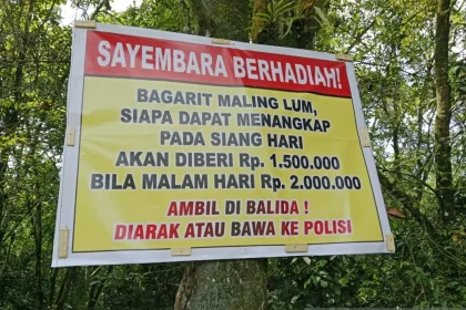 Spanduk yang dibikin warga sebagai peringatan kepada para pencuri karet di Desa Balida dan sekitarnya.